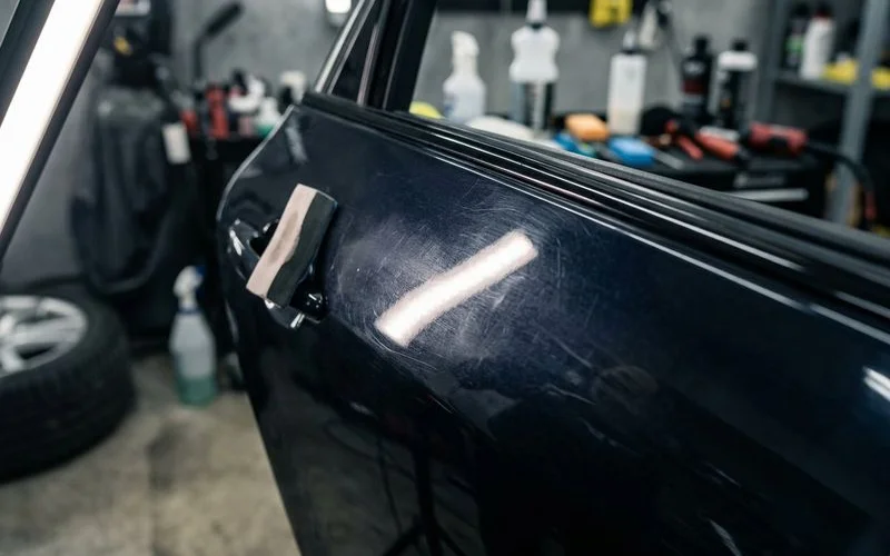 Close up of vehicle paint under magnification showing fine swirl marks that ceramic coating does not prevent