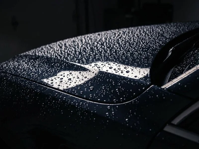 Ceramic coating with water beading on dark vehicle surface